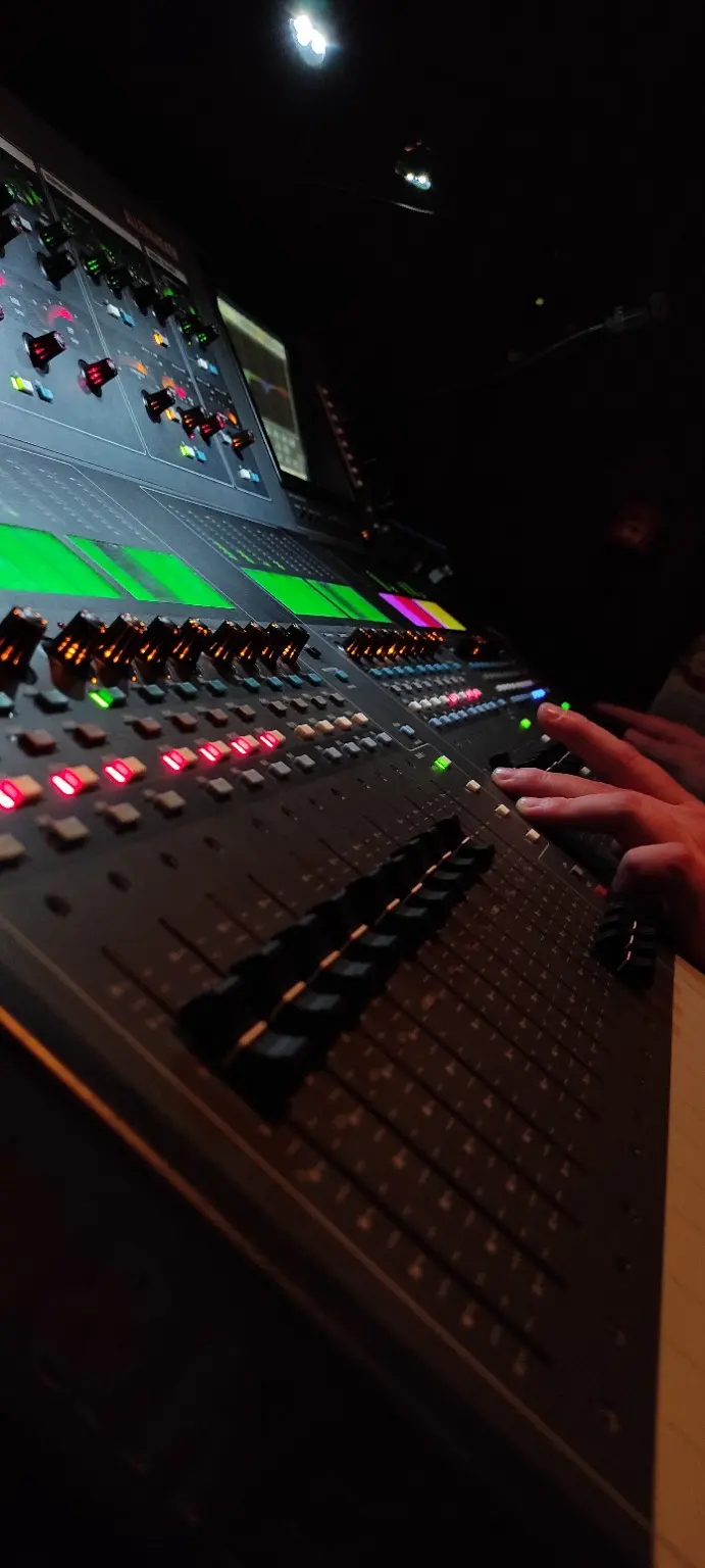 Konstantin operating a professional digital sound console in a concert hall in Witten, Germany